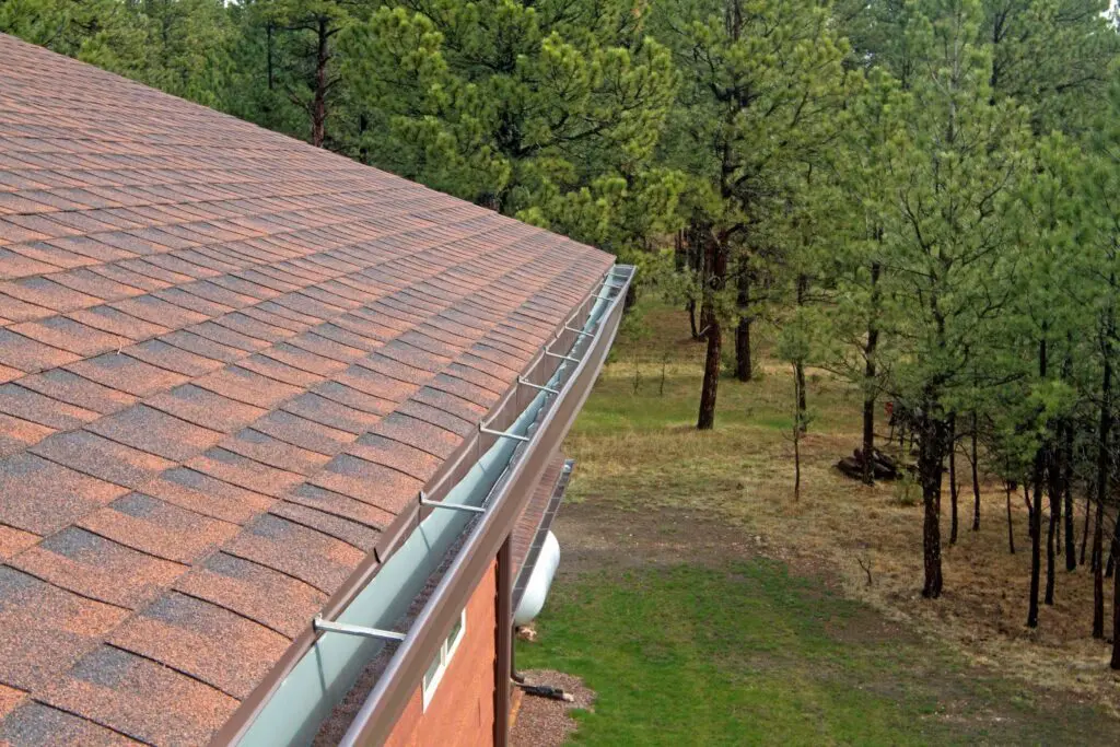 Damaged gutter on side of shingled roof