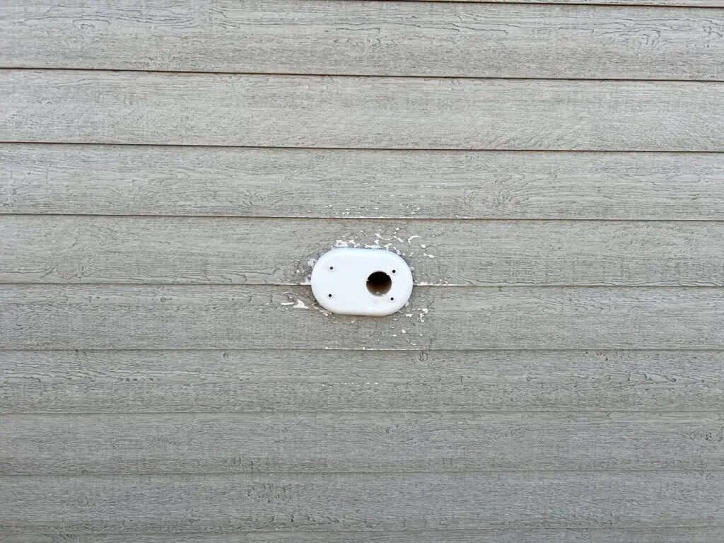 Example photo showing siding damage around intake/exhaust pipe for warranty claim