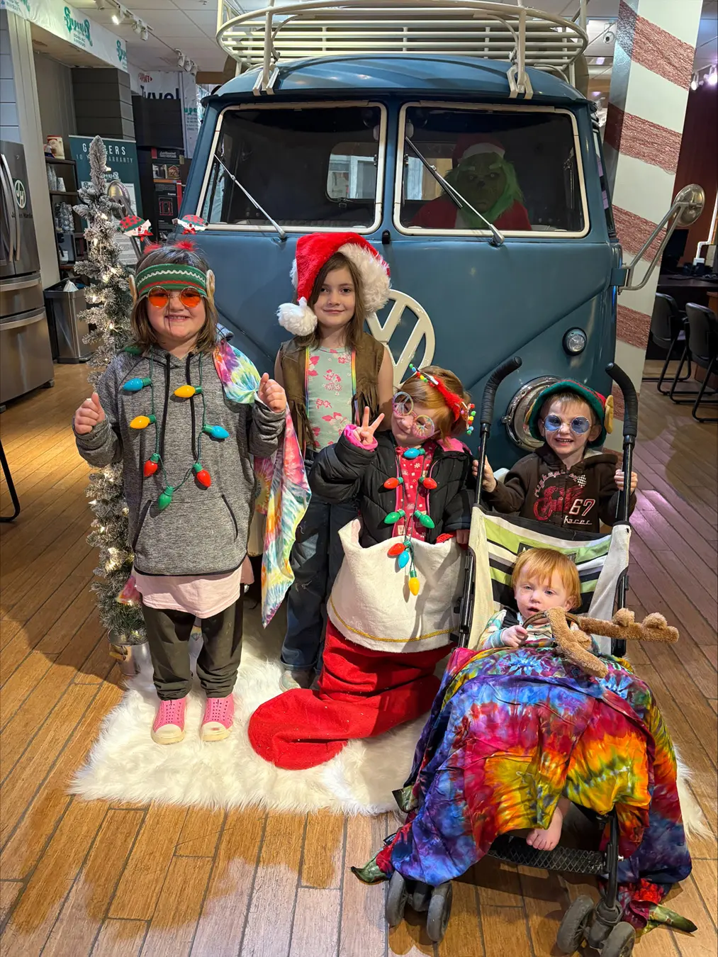 Group of kids pose for a photo in front of a VW van