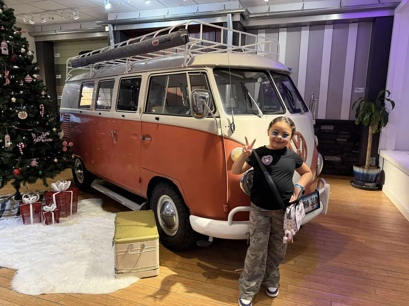 Kid poses in front of VW Van for Festive Photo