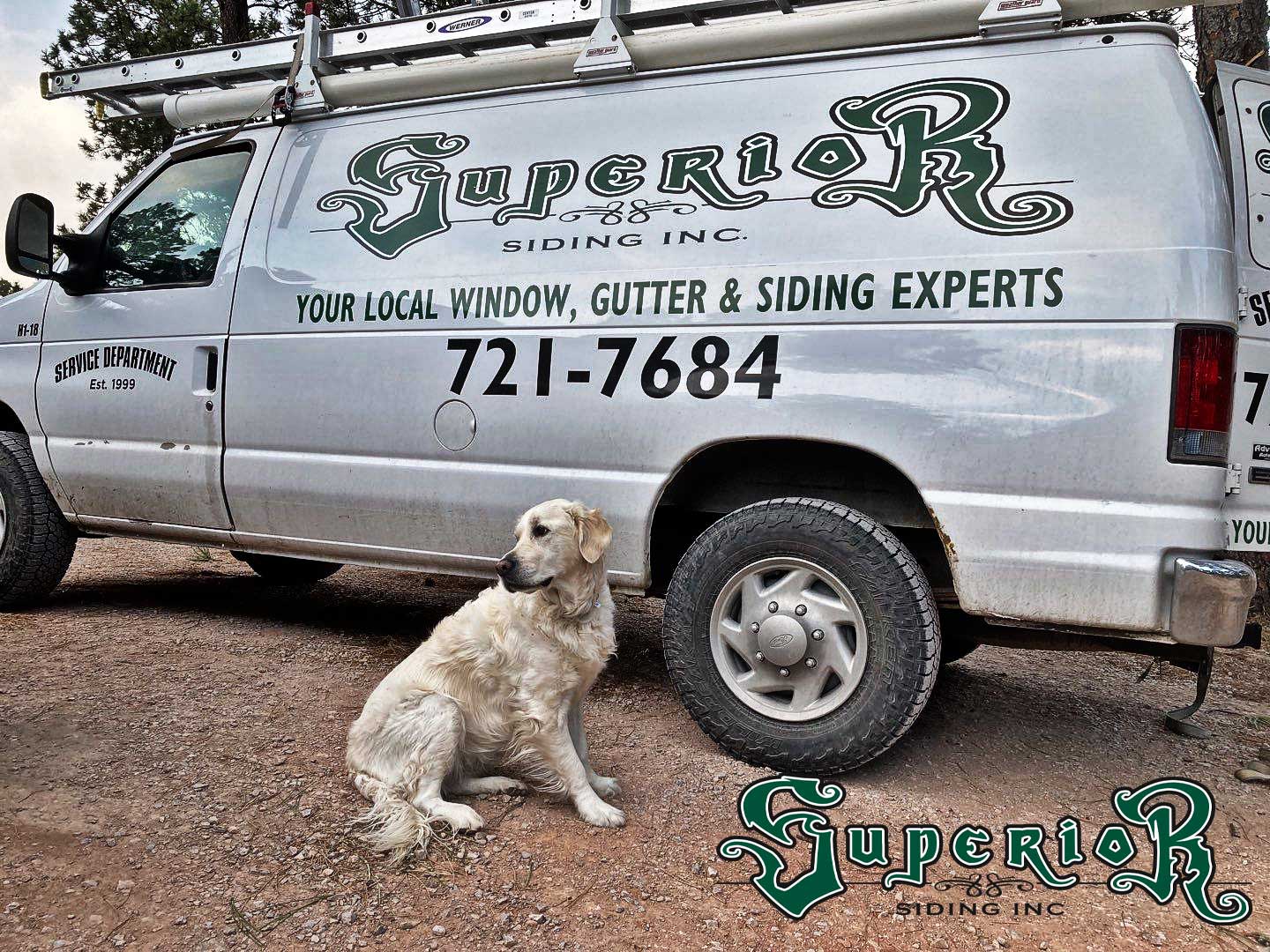 Labrador retriever in front of a Superior Siding construction van