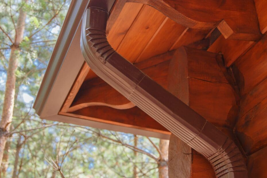 Roof gutter system on log house in forest