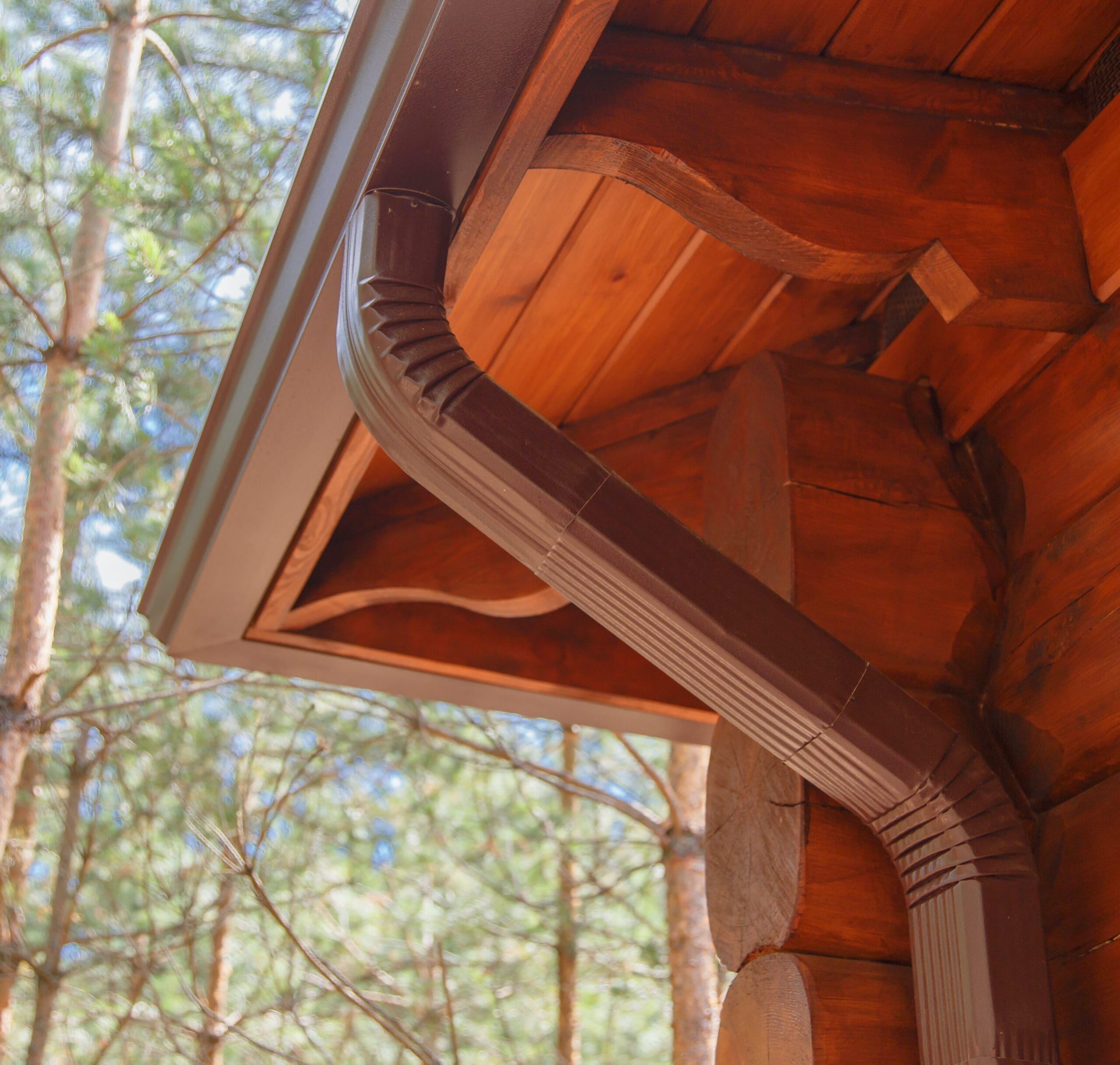 Roof gutter system on log house in forest