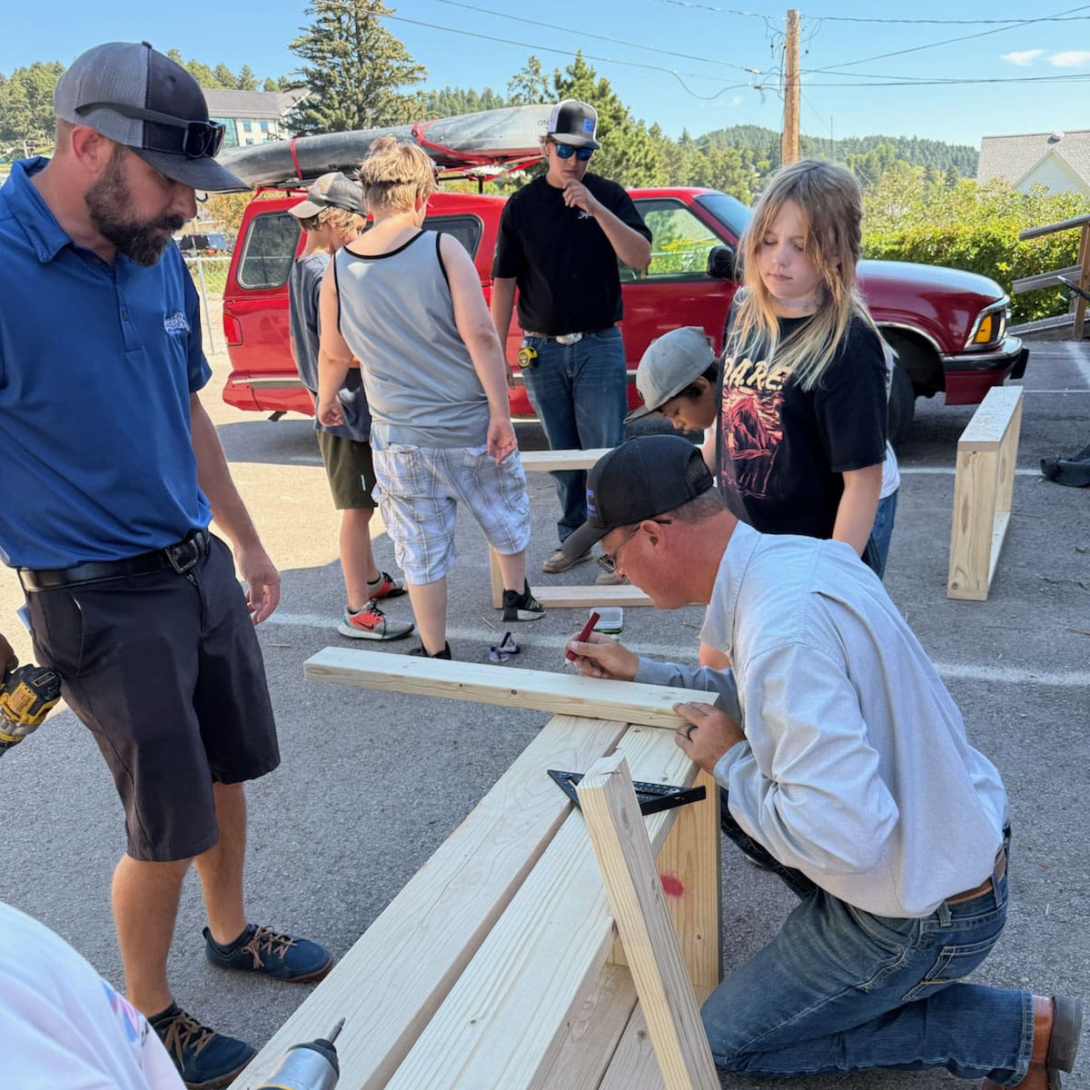 Superior Siding Employees Showing Kids how to build garden boxes