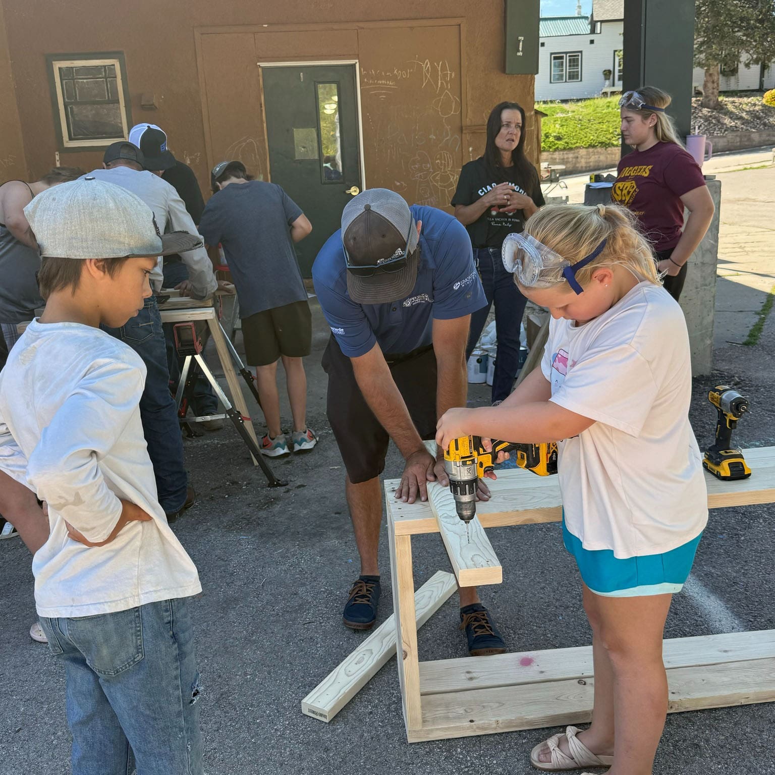 Superior Siding Employees helping children build garden boxes