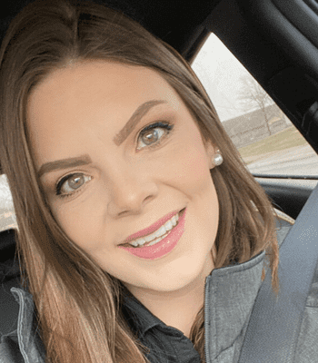 Close up headshot of Jessica smiling in her car