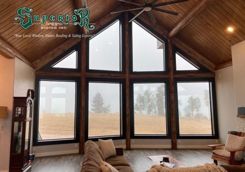 Looking out large windows of a living room to a field