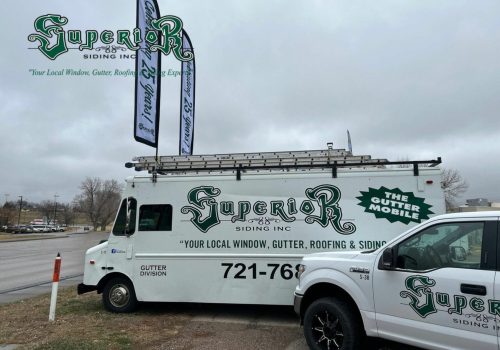 Closeup of clean gutters with Superior Siding logo on the top