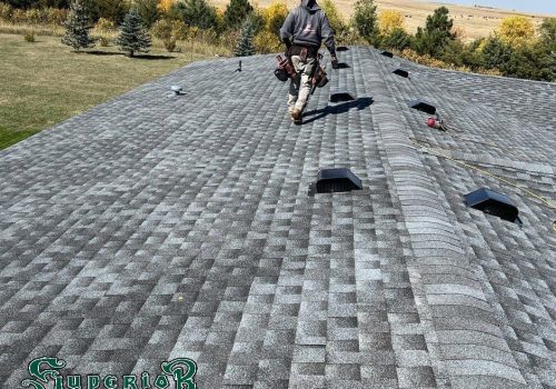 Construction worker walking away across a residential roof