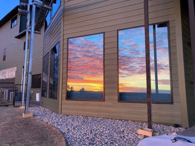 Sunset in the reflection of large house windows